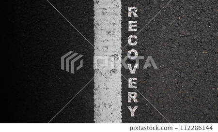 'Recovery' text on the asphalt road 112286144