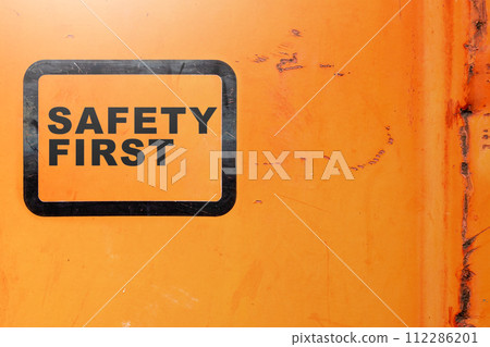 Text safety first on yellow background as a warning concept of industrial attention for employee awareness. 112286201