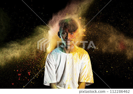 Portrait of a man celebrating Holi with colorful Holi powder Portrait of a man celebrating Holi with colorful Holi powder 112286462