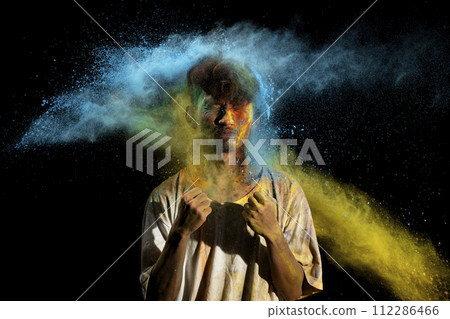 Portrait of a man celebrating Holi with colorful Holi powder 112286466