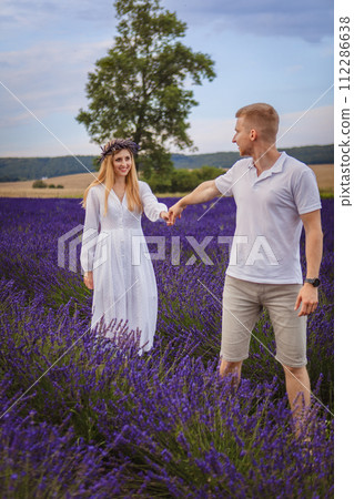 a couple in love is walking in a lavender field 112286638