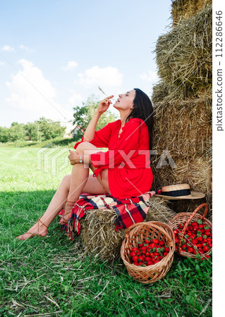 Portrait of Smiling Woman with Basket of Strawberries 112286646