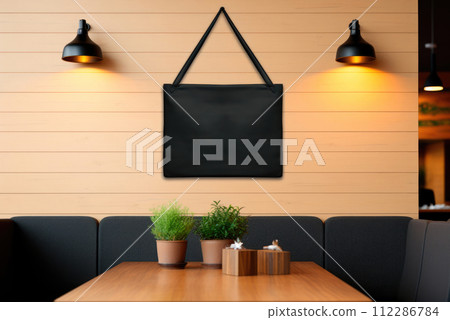 Blank black material sign plate on beige wall mock up in cafe 112286784