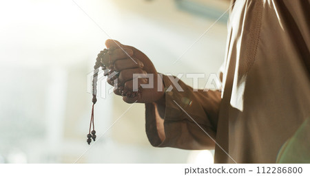 Prayer, beads and hand of muslim man in mosque, temple or Islam worship of Allah in spiritual, meditation or respect. Islamic, faith and praying in the morning for mindfulness, hope and love of God 112286800