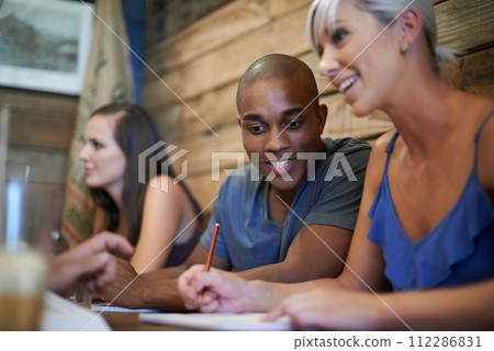 Group, happy students and learning at coffee shop, studying friends writing notes together in university. Team, people and education at cafe for college exam, test and collaboration with diversity 112286831