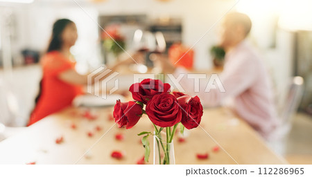 Couple, roses and toast at home with wine glass for celebration of love, romance and valentines day. People cheers for date success, drinking red champagne and luxury dinner at a table with flowers 112286965