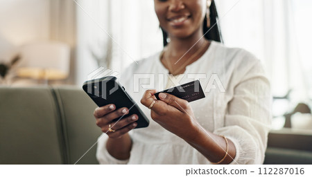 Hands, woman and credit card with smartphone on sofa for online shopping, payment and fintech at home. Closeup, mobile banking and finance for sales, password and code for ecommerce, money or savings 112287016