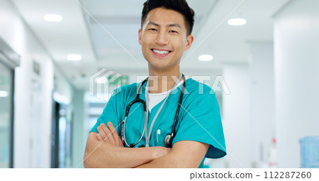 Face, doctor and confident with smile in hospital with arms crossed for leadership in medicine. Asian man, person or nurse in cardiology, emergency care or health for treatment of patient at clinic Face, doctor and confident with smile in hospital with arms crossed for leadership in medicine. Asian man, person or nurse in cardiology, emergency care or health for treatment of patient at clinic 112287260