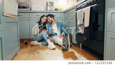 New home, renovation and couple with digital tablet on a kitchen floor for idea, search or inspiration. Real estate, property and man with woman online for creative, planning and interior design 112287288