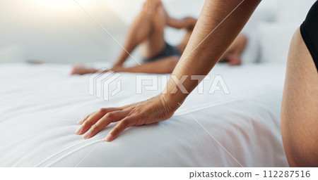 Couple, bed and hands on duvet for love, romance or intimacy in affection, morning or seduction at home. Closeup of woman and man or lovers lying in bedroom for compassion, anniversary or date 112287516