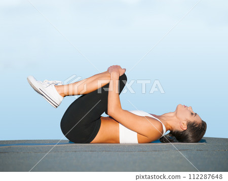 Fitness, yoga and woman on floor in studio for body workout, stretching and balance for muscle. Zen, exercise and girl on ground for healthy training on blue background with focus, wellness and care Fitness, yoga and woman on floor in studio for body workout, stretching and balance for muscle. Zen, exercise and girl on ground for healthy training on blue background with focus, wellness and care 112287648