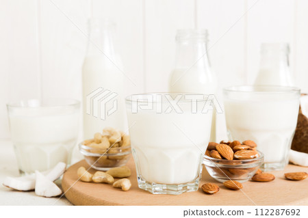 Set or collection of various vegan milk almond, coconut, cashew, on table background. Vegan plant based milk and ingredients, top view Set or collection of various vegan milk almond, coconut, cashew, on table background. Vegan plant based milk and ingredients, top view 112287692