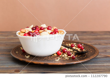 Healthy breakfast food with granola, yogurt, fruits and nuts. Dessert parfait with dried fruits for breakfast Healthy breakfast food with granola, yogurt, fruits and nuts. Dessert parfait with dried fruits for breakfast 112287790