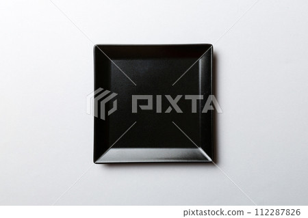 Top view of isolated of colored background empty square black plate for food. Empty dish with space for your design 112287826