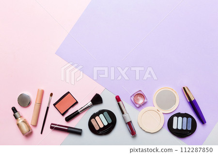Professional makeup tools. Top view. Flat lay. Beauty, decorative cosmetics. Makeup brushes set and color eyeshadow palette on table background. Minimalistic style Professional makeup tools. Top view. Flat lay. Beauty, decorative cosmetics. Makeup brushes set and color eyeshadow palette on table background. Minimalistic style 112287850