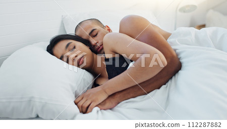 Couple, hugging and sleeping in bed together, love and resting or comfortable at home on weekend. People, bedroom and security in embrace, bonding and nap on sunday morning and relaxing or dreaming Couple, hugging and sleeping in bed together, love and resting or comfortable at home on weekend. People, bedroom and security in embrace, bonding and nap on sunday morning and relaxing or dreaming 112287882