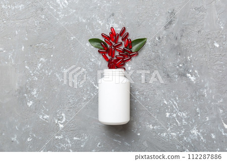 different drugs and health supplement pills poured from a medicine bottle health care and medical top view on colored background different drugs and health supplement pills poured from a medicine bottle health care and medical top view on colored background 112287886