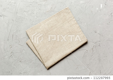 top view with gray kitchen napkin isolated on table background. Folded cloth for mockup with copy space, Flat lay. Minimal style top view with gray kitchen napkin isolated on table background. Folded cloth for mockup with copy space, Flat lay. Minimal style 112287993