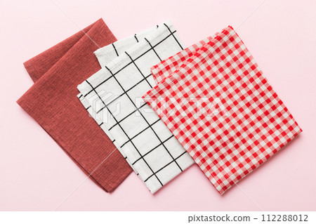 top view with red empty kitchen napkin isolated on table background. Folded cloth for mockup with copy space, Flat lay. Minimal style 112288012