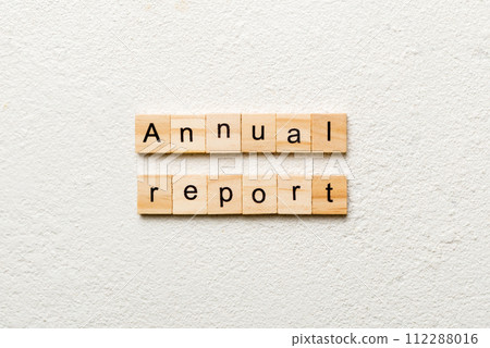 Annual report word written on wood block. Annual report text on cement table for your desing, concept 112288016