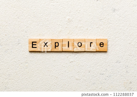 Explore word written on wood block. Explore text on cement table for your desing, concept Explore word written on wood block. Explore text on cement table for your desing, concept 112288037