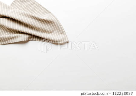 top view with gray kitchen napkin isolated on table background. Folded cloth for mockup with copy space, Flat lay. Minimal style 112288057