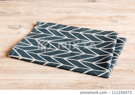 top view with blue kitchen napkin isolated on table background. Folded cloth for mockup with copy space, Flat lay. Minimal style top view with blue kitchen napkin isolated on table background. Folded cloth for mockup with copy space, Flat lay. Minimal style 112288073