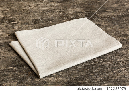 top view with gray kitchen napkin isolated on table background. Folded cloth for mockup with copy space, Flat lay. Minimal style 112288079