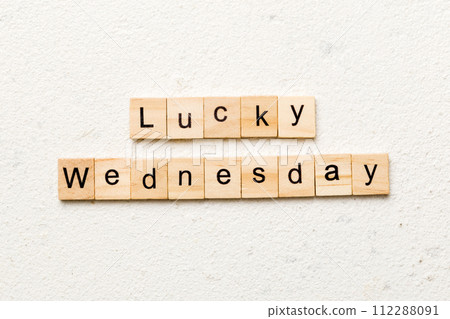 lucky wednesday word written on wood block. lucky wednesday text on cement table for your desing, concept 112288091