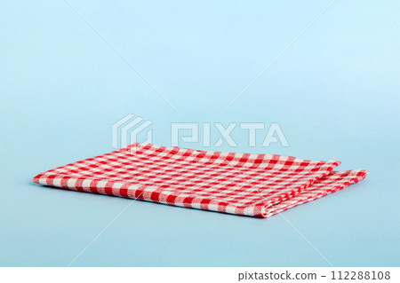 top view with red empty kitchen napkin isolated on table background. Folded cloth for mockup with copy space, Flat lay. Minimal style 112288108