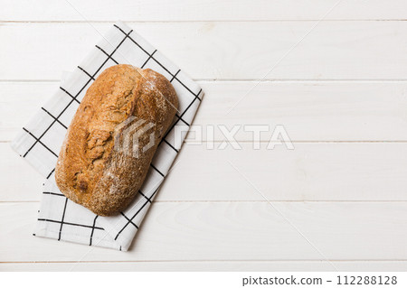 Fresh Homemade Whole Wheat Bread. bread on napkin on rustic background, fresh bread top view 112288128
