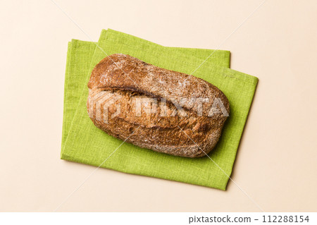 Fresh Homemade Whole Wheat Bread. bread on napkin on rustic background, fresh bread top view 112288154