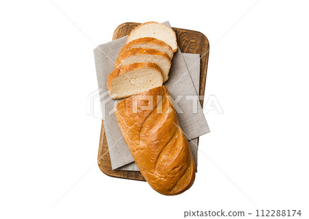 Freshly baked bread slices on cutting board isolated on white background . top view Sliced bread Freshly baked bread slices on cutting board isolated on white background . top view Sliced bread 112288174