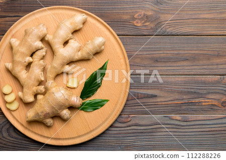 ginger on Cutting board table, top view. Space for text ginger on Cutting board table, top view. Space for text 112288226