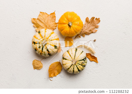 Autumn composition. Pattern made of dried leaves and other design accessories on table. Flat lay, top view Autumn composition. Pattern made of dried leaves and other design accessories on table. Flat lay, top view 112288232