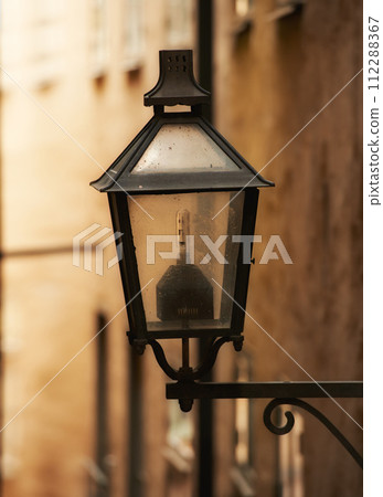Travel, architecture and lamp on retro building in old town with history, culture or holiday destination in Sweden. Vacation, landmark and antique lantern in Stockholm with vintage light ancient city Travel, architecture and lamp on retro building in old town with history, culture or holiday destination in Sweden. Vacation, landmark and antique lantern in Stockholm with vintage light ancient city 112288367