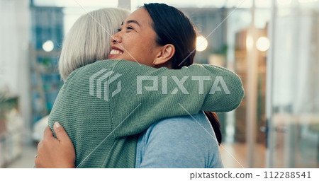 Senior woman, hug and old friend at a business office with a smile, support and excited. Elderly person, love and happy women together at a workplace with care from staff at physiotherapy with health 112288541