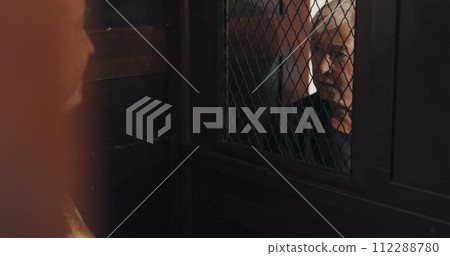 Priest, talking and listening in confession booth with senior woman, sinner or secret for forgiveness in church. Holy father, elderly lady and speaking for mental health, sorry or connection with God 112288780
