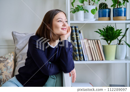 Portrait of young smiling woman in home interior Portrait of young smiling woman in home interior 112289097