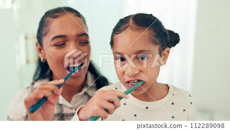 Brushing teeth, mother and daughter with toothbrush, portrait and dental for health, morning routine and happy. Bathroom, home and hygiene with mama, girl and oral care with cleaning mouth and child 112289098