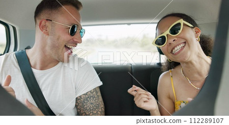 Singing, dancing and couple in car on road trip in countryside listening to music together. Happy, love and young man and woman moving to song, playlist or radio in vehicle on holiday or adventure. 112289107
