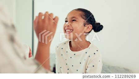 Young child, skincare and laugh for lotion, smile and morning hygiene for wellness. Cream, girl and moisturizer with youth, family and home in bathroom, sunscreen and facial care and cosmetics 112289269