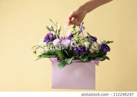 Beautiful, fresh flowers in a gift bag. 112290297