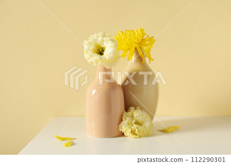 Fresh flowers in a vase on a light background. 112290301