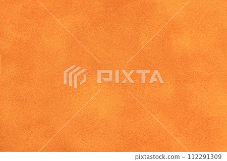 Bright orange matte background of suede fabric, closeup. Velvet texture of pumpkin textile, macro. 112291309