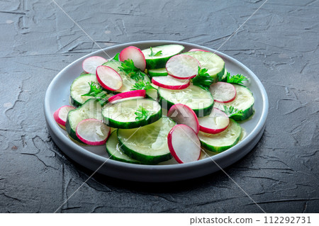 Fresh cucumber and radish salad with parsley. Simple vegan recipe Fresh cucumber and radish salad with parsley. Simple vegan recipe 112292731