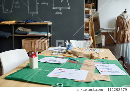 Background image of atelier workshop interior with sewing patterns on table, copy space Background image of atelier workshop interior with sewing patterns on table, copy space 112292879