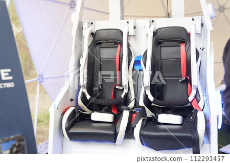 Virtual reality attraction with two black chairs, seats and two virtual headset, glasses of virtual reality in virtual play room. Concept of game,  112293457