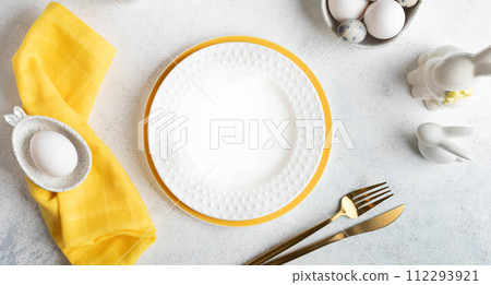 Easter table setting mock up. Restaurant festive menu template in white and yellow. Top view. Banner 112293921