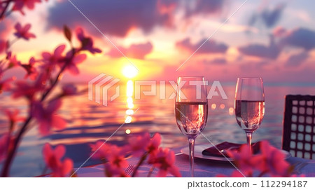 Beach Dining Set with Wine and Flowers at Sunset 112294187